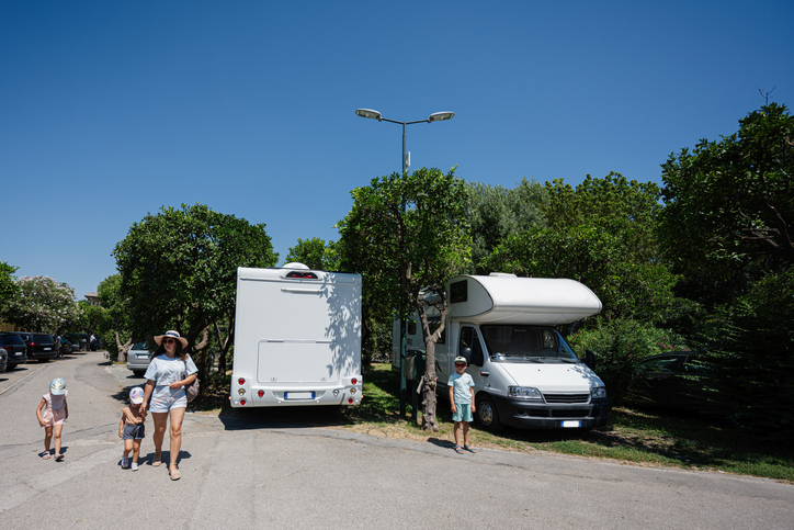 Family on side of road outside their Class C motorhome