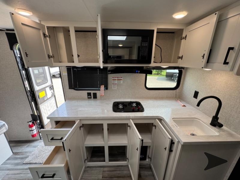 kitchen of Jay Flight 160LK with cabinets open to show storage space