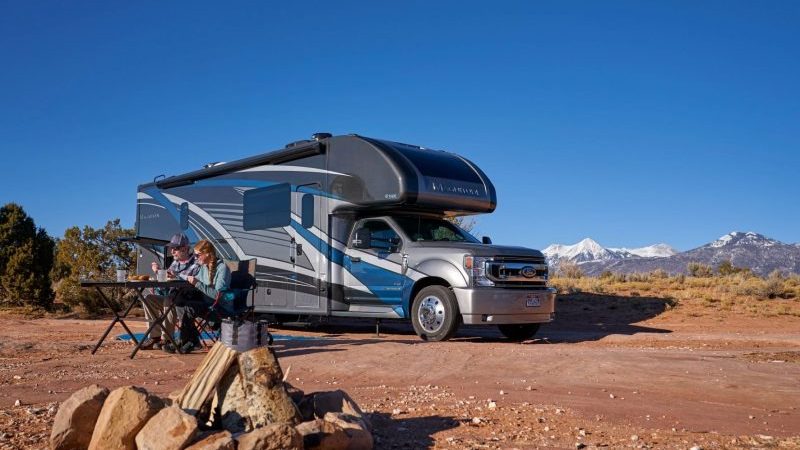 class C in desert with couple outside