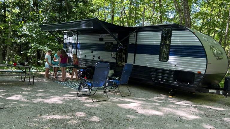 family camping outside Grey Wolf Camper