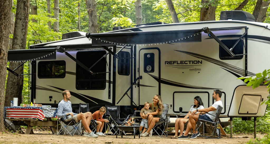 family sitting outside Reflection 5th wheel