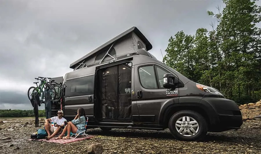 couple outside class b camper van