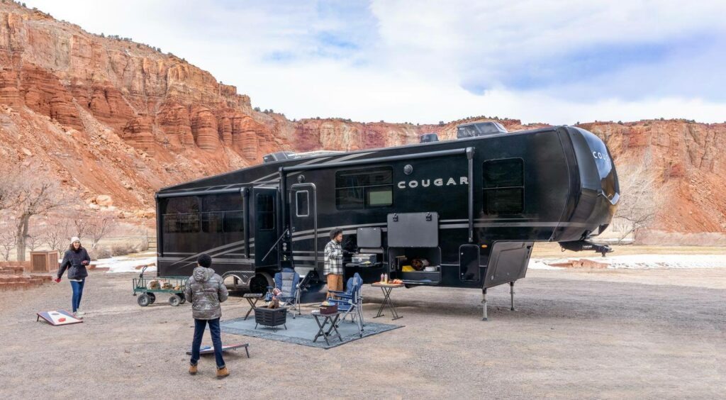 Family outside their Cougar 5th wheel in redstone canyon