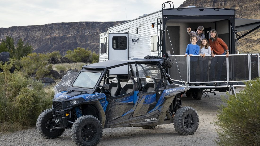 family ouside their toy hauler travel trailer with RPolaris ATV