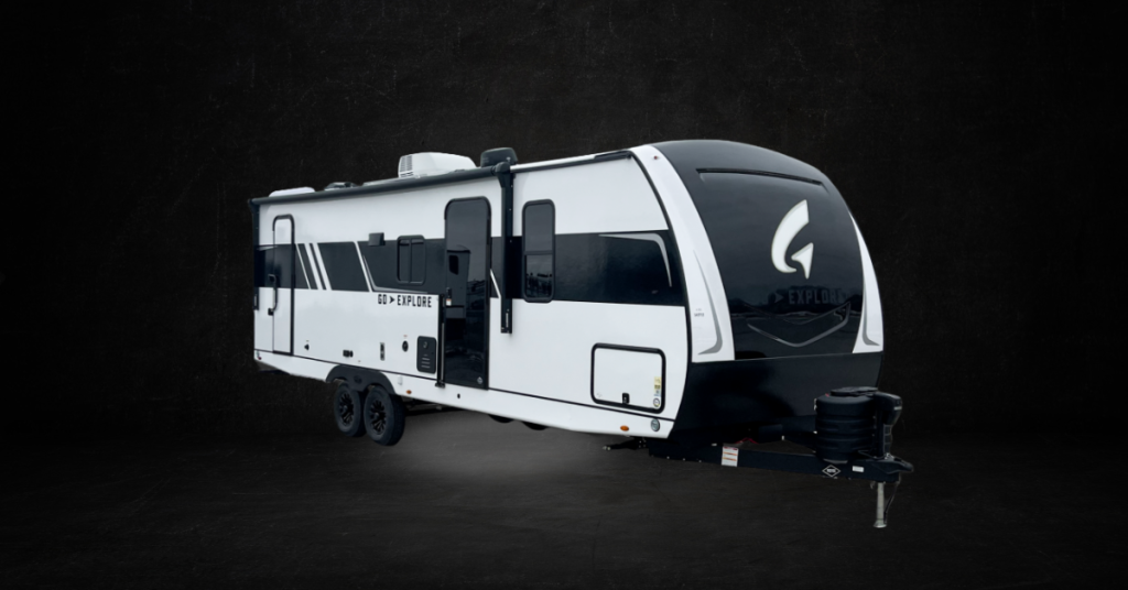 Elegant travel trailer with a streamlined, aerodynamic design, featuring a glossy black front cap accented by an illuminated 'G' logo. The side panels are white with bold black graphics, including the text 'GO > EXPLORE' on the side. The trailer is equipped with dual black alloy wheels, large tinted windows, and a front hitch with a protective cover. Set against a dark, dramatic background, the trailer stands out as a sleek and modern adventure vehicle.