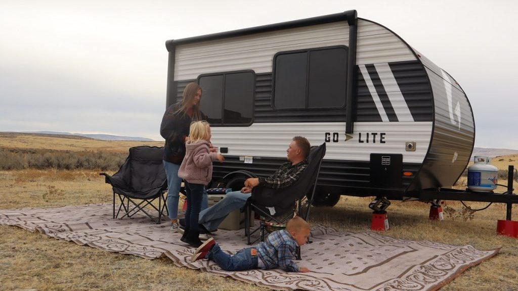 family outside a small Go Lite travel trailer